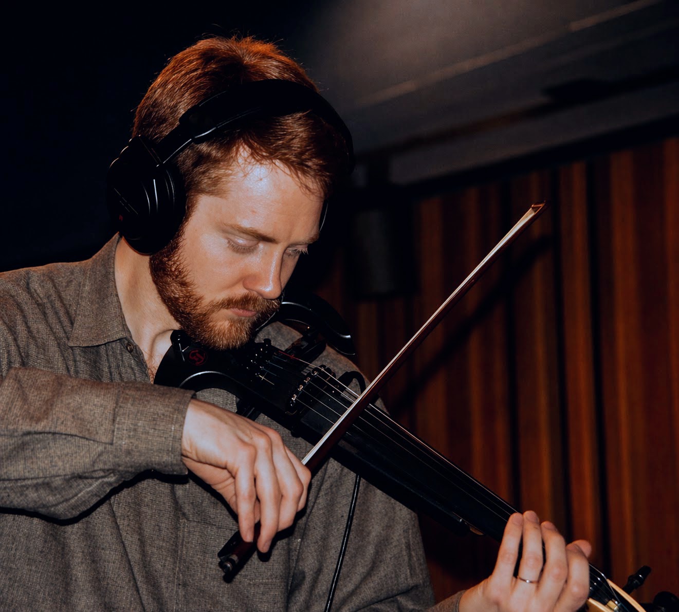 Barry Hall performing on electric violin and bass.