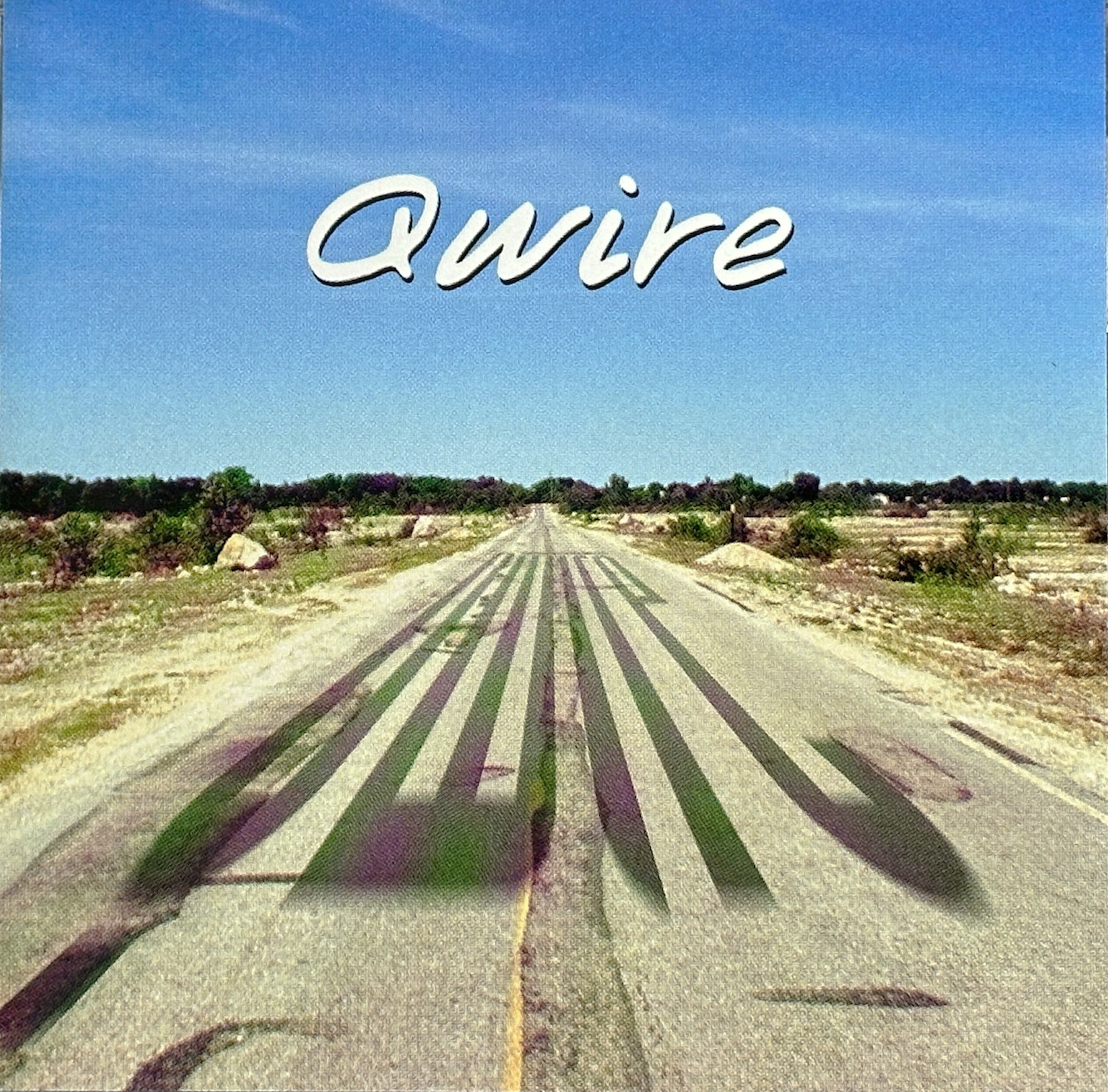 Qwire cover art showing a road stretching into the distance under a blue sky with the band name overhead.